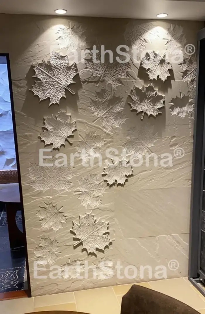 Mapple leaf with light on natural stone wall carving art